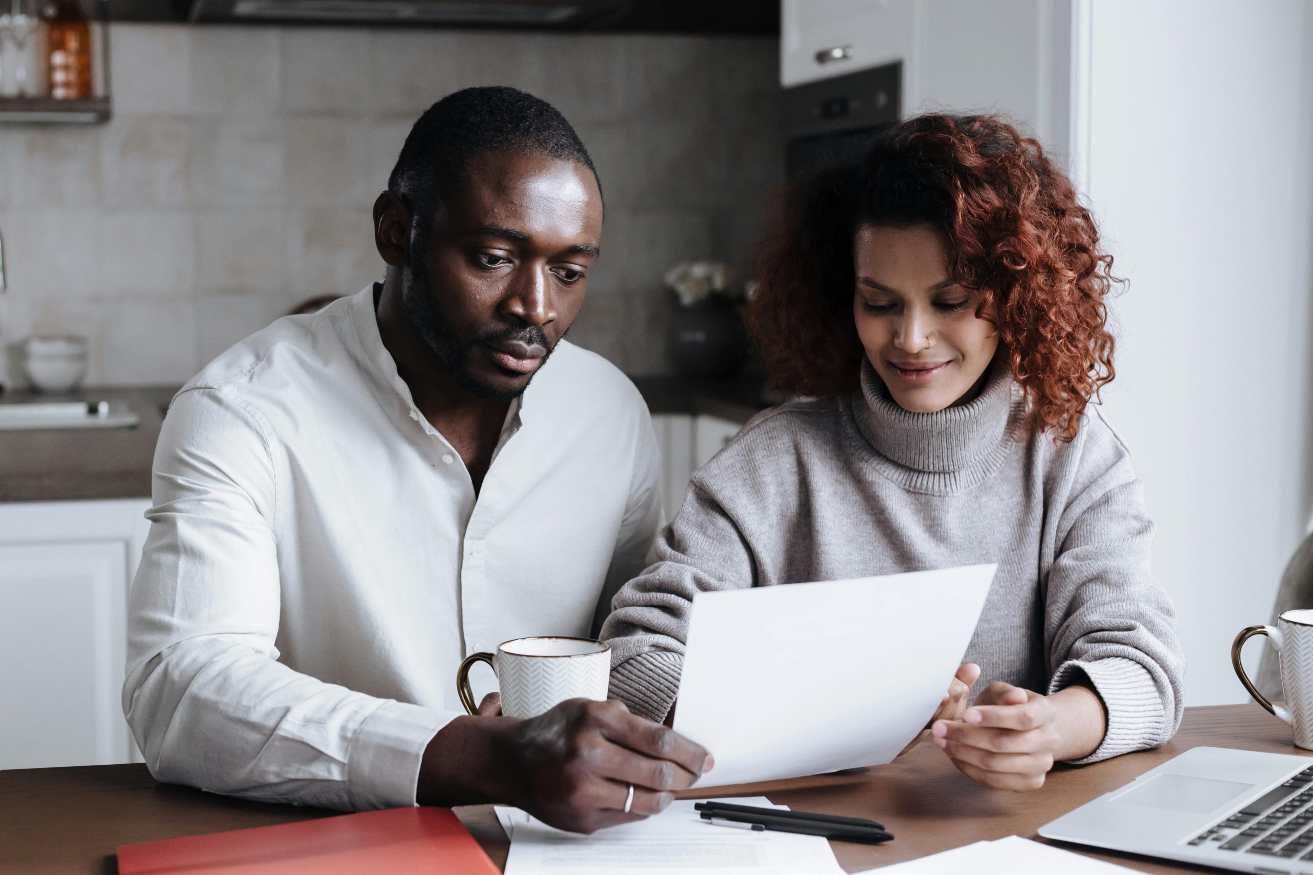 couple reviewing their mortgage statement at home